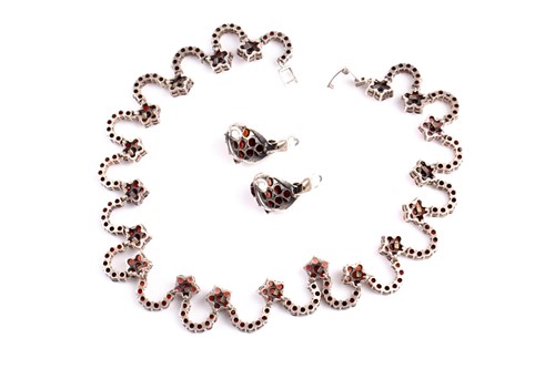 Lot 544 - A silver and garnet dress necklace, formed of...