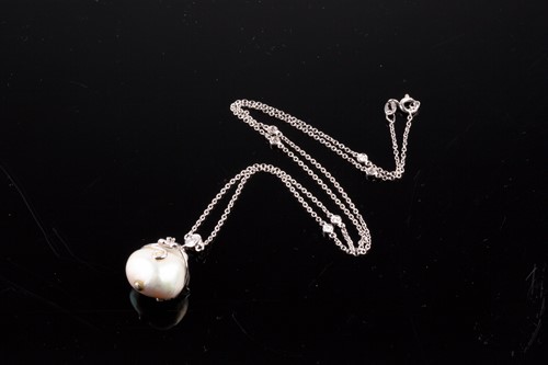 Lot 455 - An 18ct white gold, diamond, and pearl pendant...
