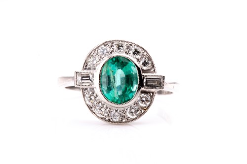 Lot 852 - A platinum, diamond, and emerald ring, set...