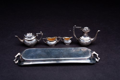 Lot 24 - A novelty silver miniature tea set, comprised...