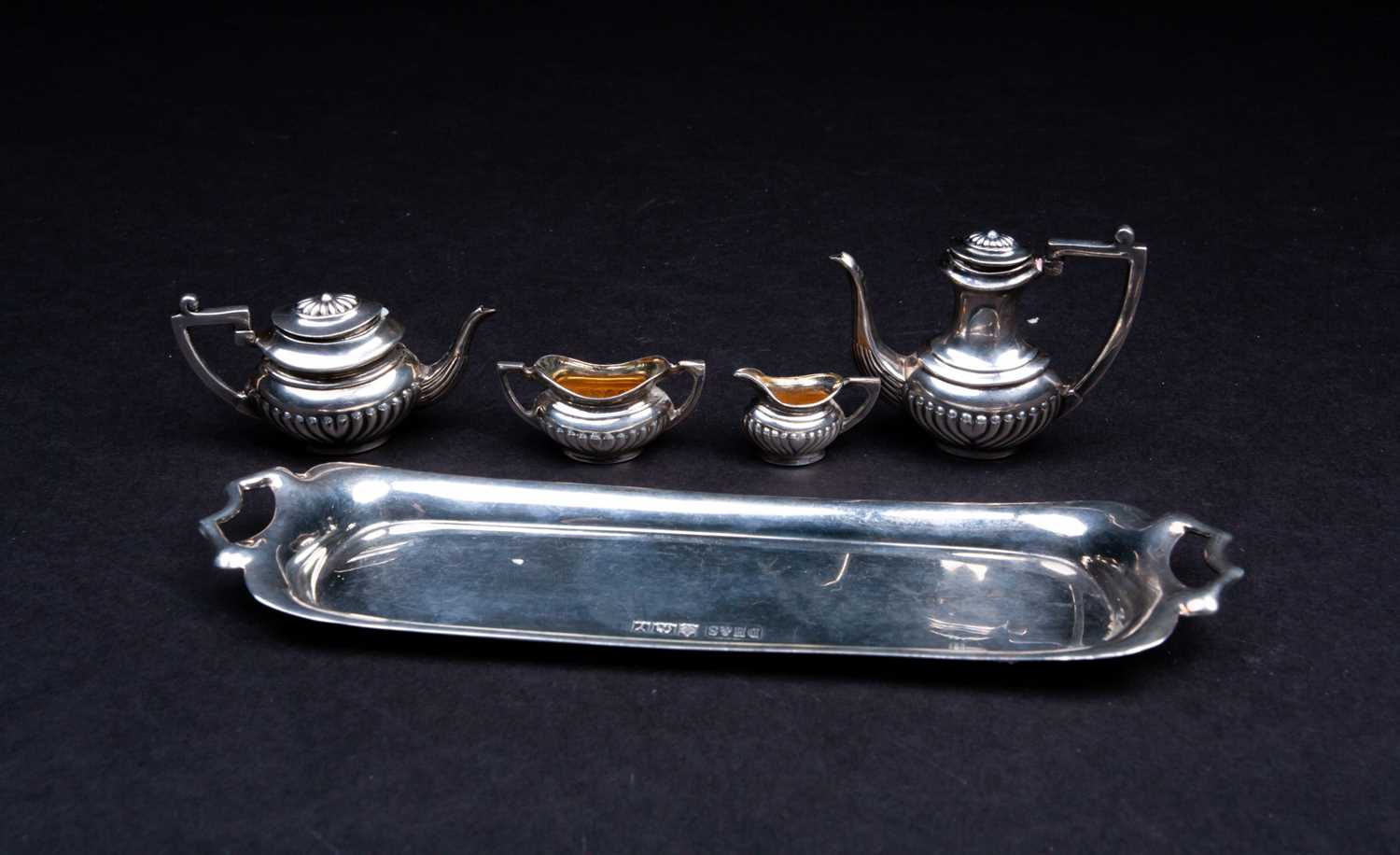 Lot 24 - A novelty silver miniature tea set, comprised...