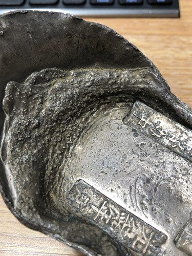 Lot 104 - A Chinese sycee silver ingot of abstract boat...