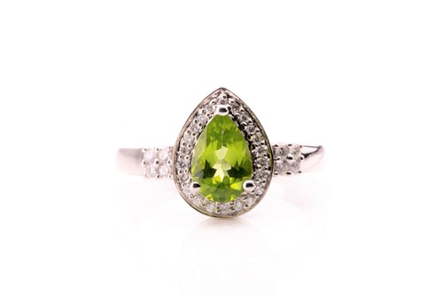 Lot 766 - A 14ct white gold, diamond, and peridot ring,...