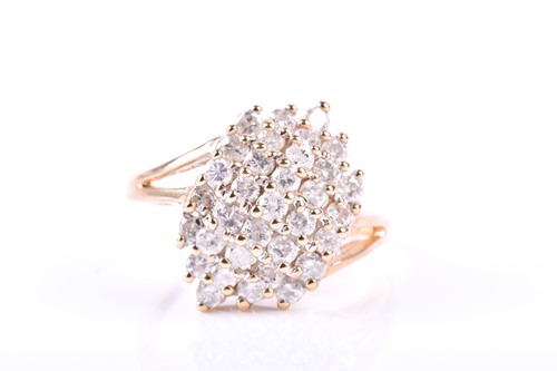 Lot 705 - A yellow metal and diamond cluster ring, the...