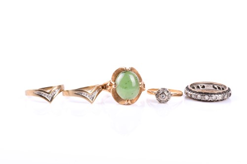 Lot 774 - A yellow metal and green hardstone ring, set...