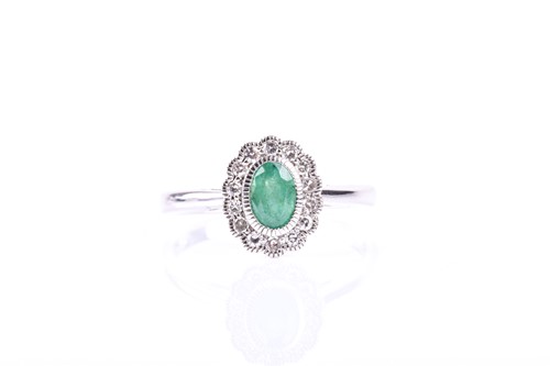 Lot 648 - An emerald and diamond cluster ring, the oval...