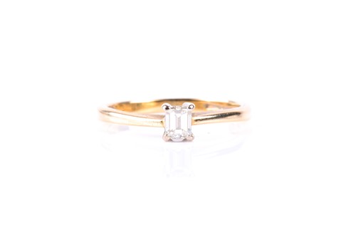 Lot 749 - A single stone emerald cut diamond ring, in...