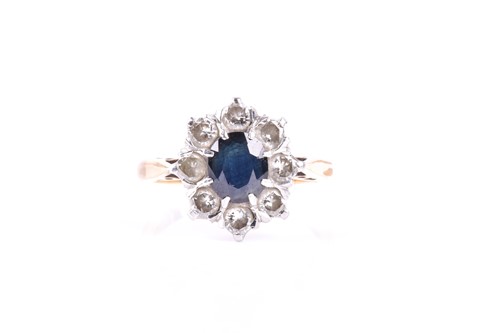 Lot 427 - A sapphire and diamond cluster ring, the...