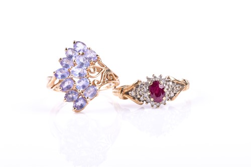 Lot 882 - A ruby and diamond cluster ring, the central...