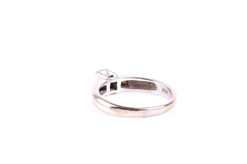 Lot 404 - A baguette diamond ring, the central baguette...