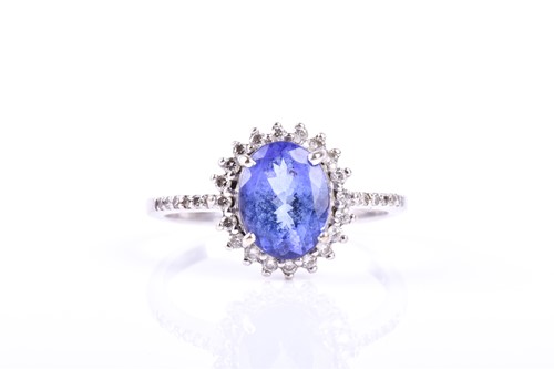 Lot 494 - A tanzanite and diamond cluster ring, the oval...