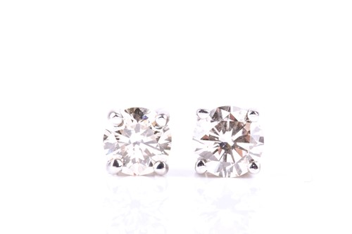 Lot 770 - A pair of single stone diamond earrings, the...