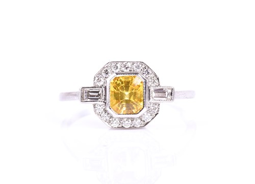 Lot 190 - A platinum, diamond, and yellow sapphire ring,...