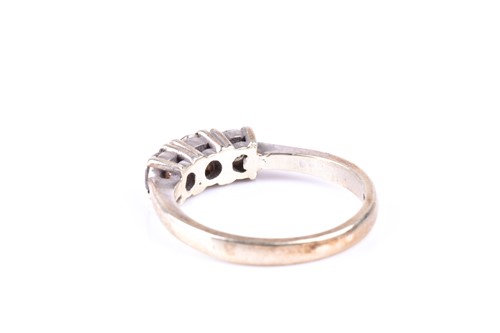 Lot 341 - A three stone diamond half hoop ring, the...