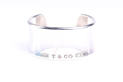 Lot 655 - A Tiffany & Co cuff bangle, the slightly...