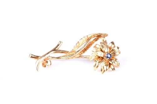 Lot 832 - An 18 carat gold and sapphire flower brooch;...