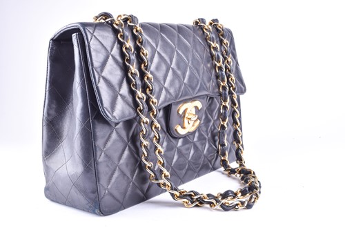 Lot 323 - Chanel. A classic single flap black leather...