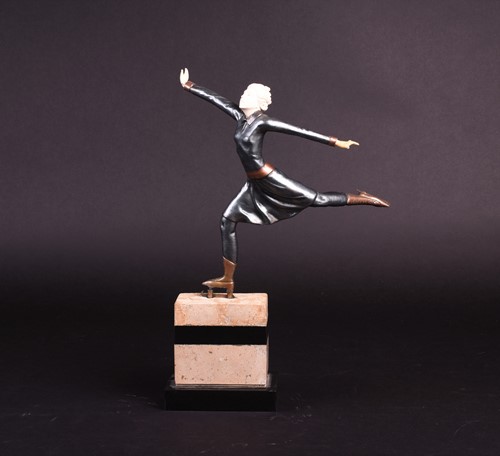 Lot 398 - An Art Deco style patinated spelter ice skater,...