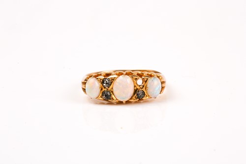 Lot 828 - An 18ct yellow gold, opal, and diamond ring,...