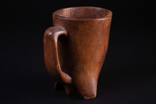 Lot 65 - An African carved wood palm wine cup, third...