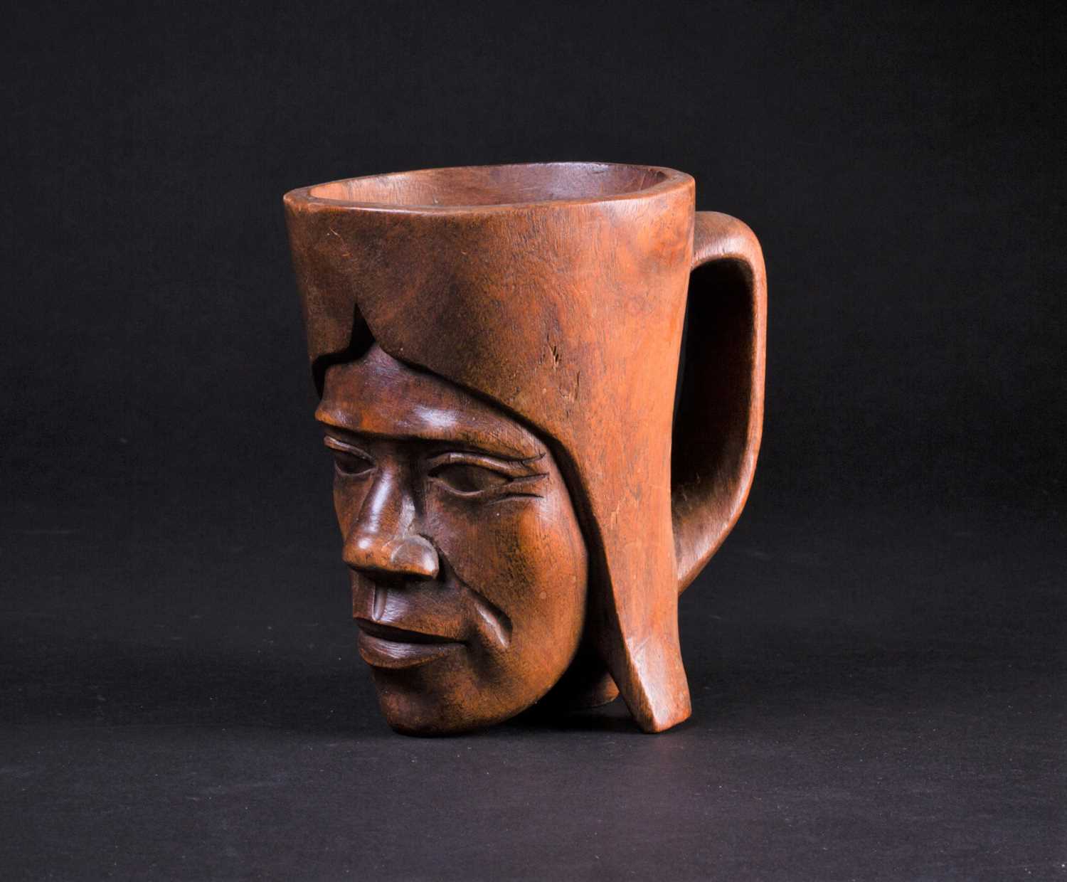 Lot 65 - An African carved wood palm wine cup, third...