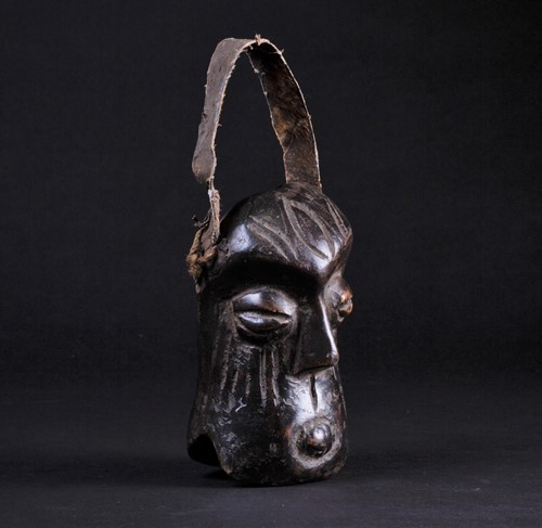Lot 54 - An African carved wood miniature mask/bell,...