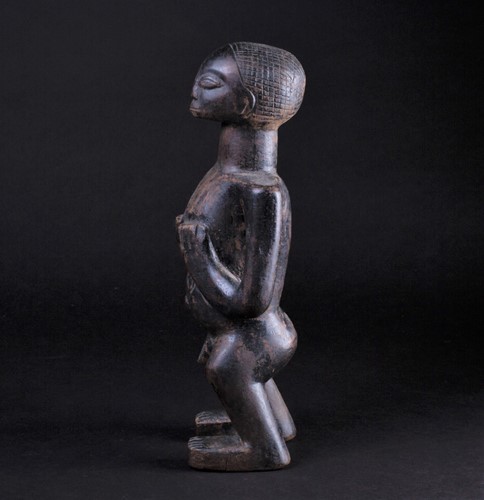 Lot 38 - An East African standing male fertility figure,...