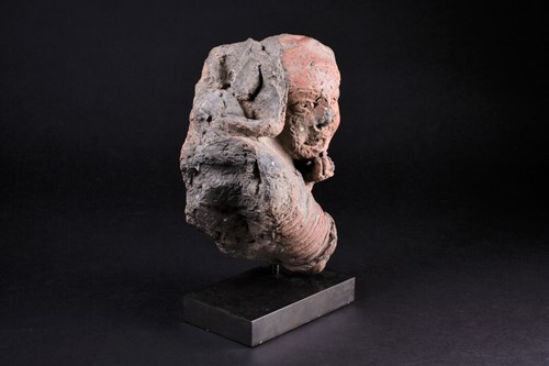 Lot 12 - An African terracotta bust of a child, an arm...