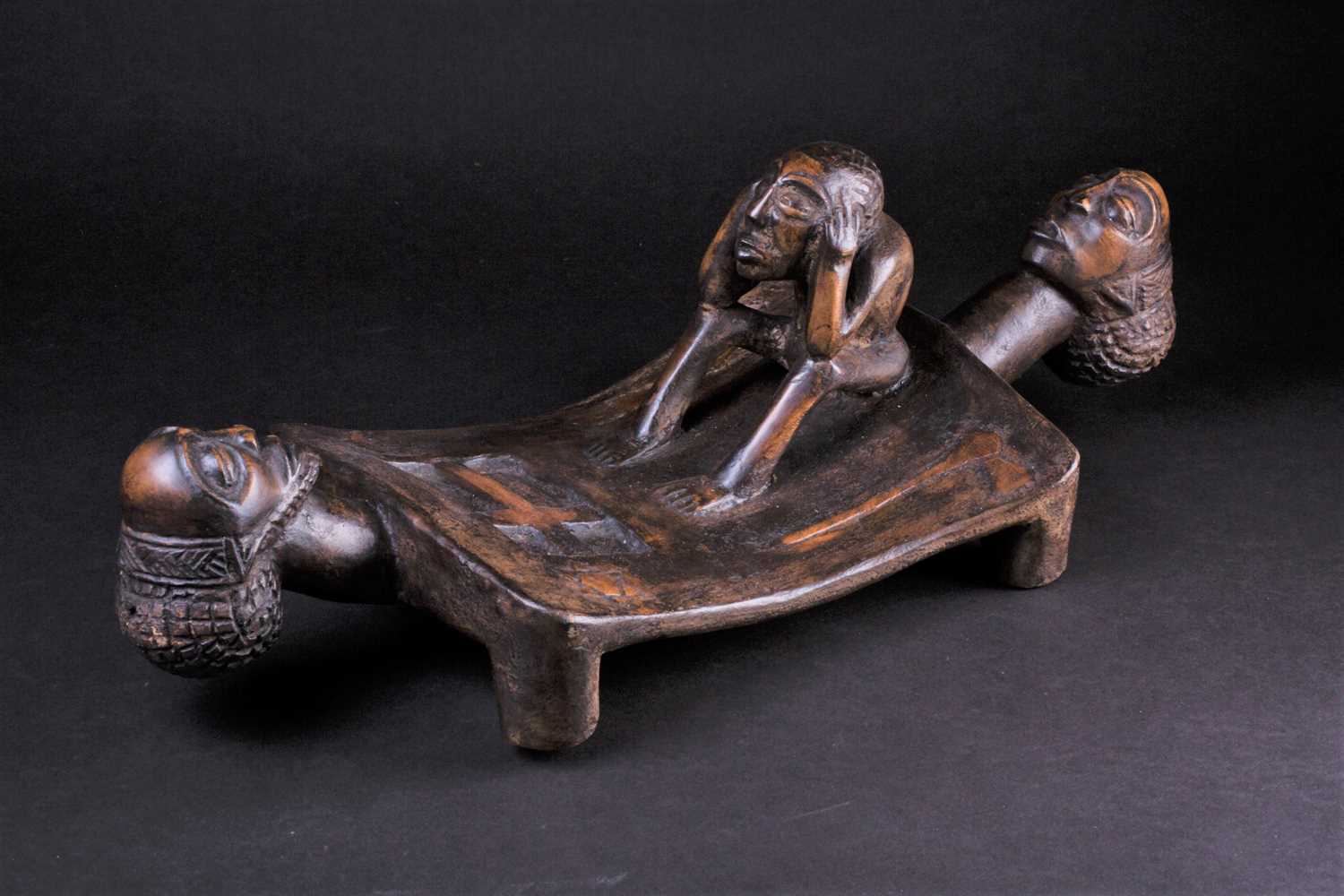 Lot 68 - A Chokwe carved wood head rest, in the form of...