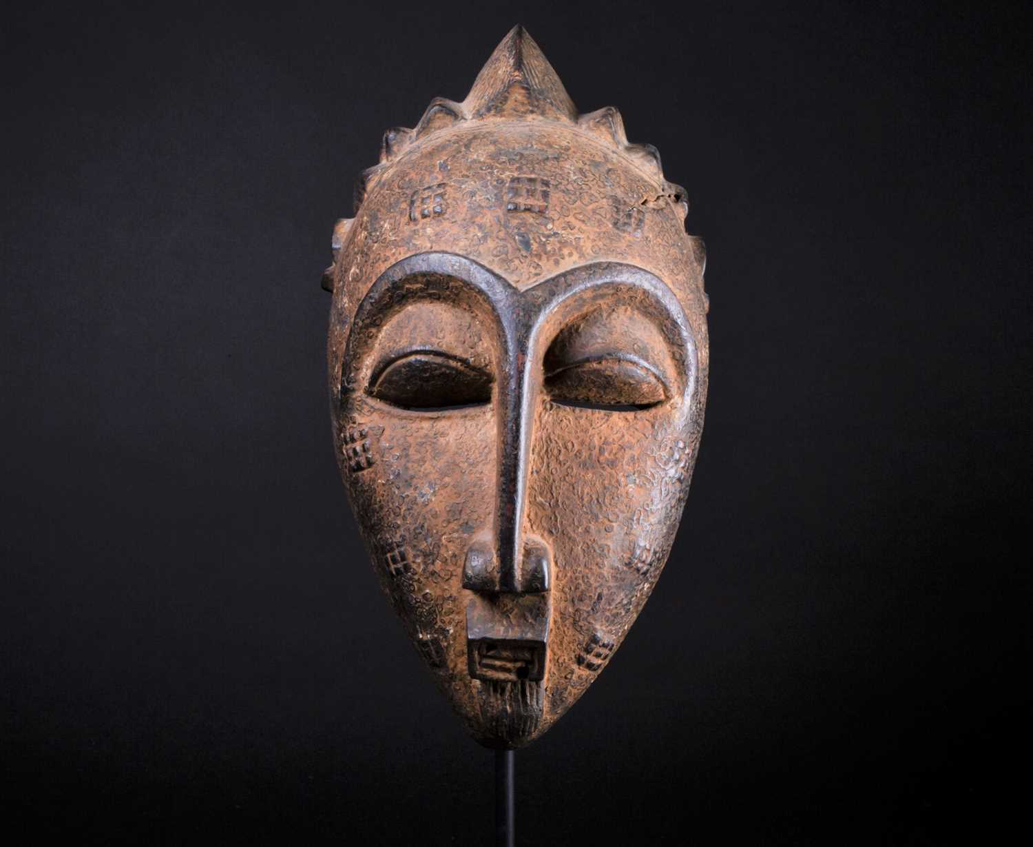 Lot 50 - A Punu mask, Gabon, with short linear coiffure...
