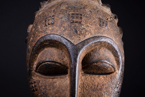 Lot 50 - A Punu mask, Gabon, with short linear coiffure...