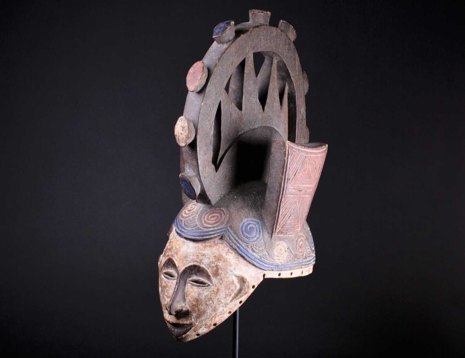 Lot 24 - An Igbo Maiden Spirit mask, Nigeria, in red,...