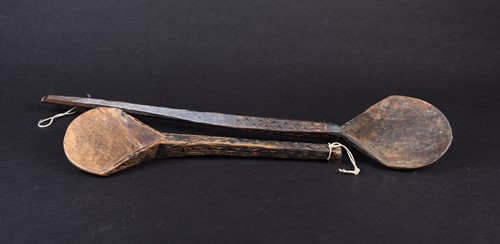 Lot 27 - Two African carved wood spoons, each with...