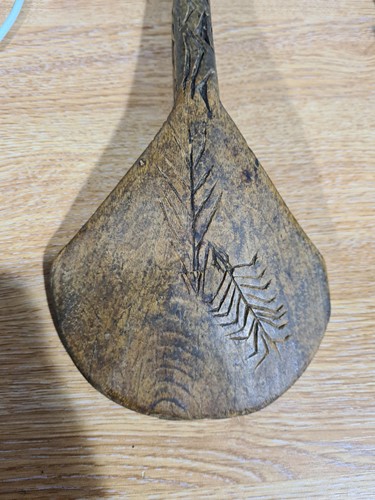 Lot 27 - Two African carved wood spoons, each with...