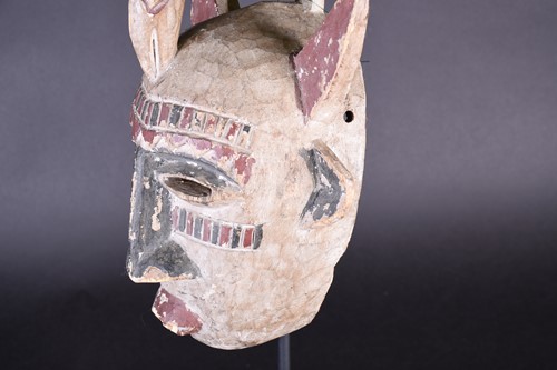 Lot 118 - A Guro mask, Ivory Coast, painted red and...