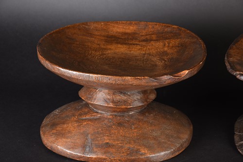 Lot 131 - Two African hardwood low stools, each of dumb...