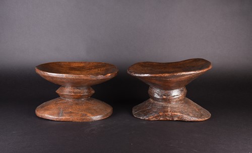 Lot 131 - Two African hardwood low stools, each of dumb...