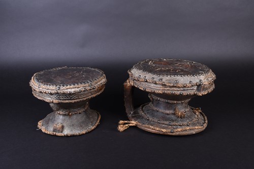 Lot 121 - A near pair of West African hardwood drums, of...