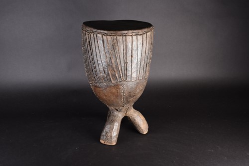 Lot 97 - A West African freestanding drum, the wood...