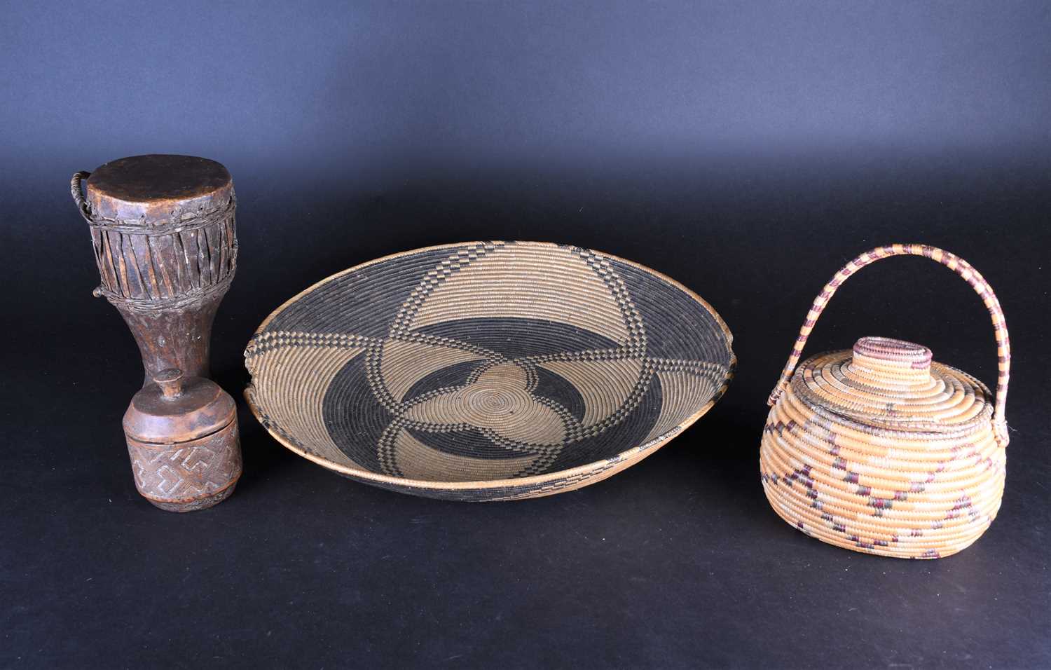 Lot 92 - A large South African woven straw shallow bowl,...