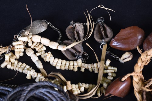 Lot 107 - African jewellery, comprising four seed pod...