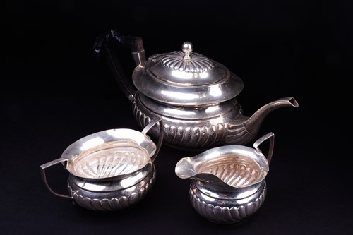 Lot 535 - A three piece white metal teaset, comprising...