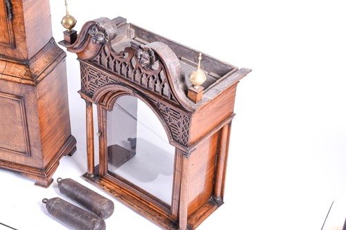 Lot 530 - A Georgian walnut long case clock, the arched...
