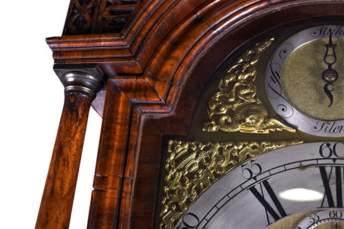Lot 530 - A Georgian walnut long case clock, the arched...