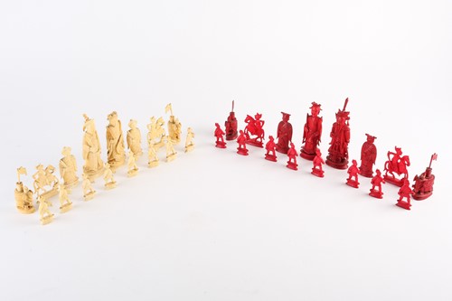 Lot 202 - A Chinese natural and red stained ivory chess...