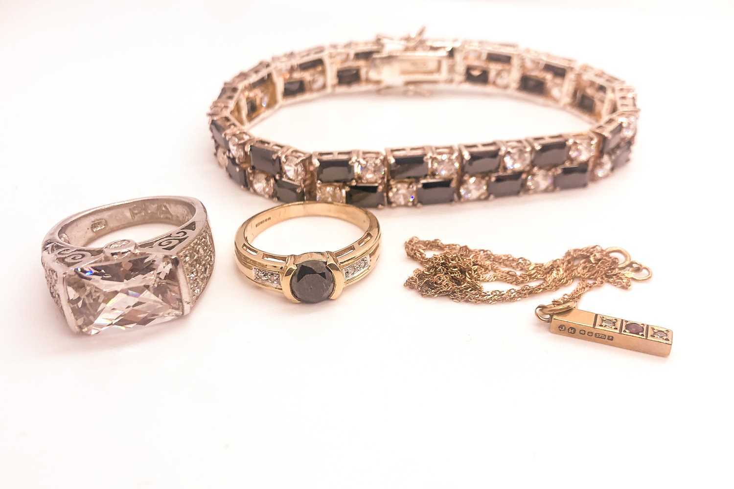 Lot 746 - A 9ct yellow gold and black CZ ring, together...