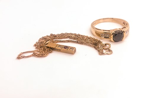 Lot 746 - A 9ct yellow gold and black CZ ring, together...