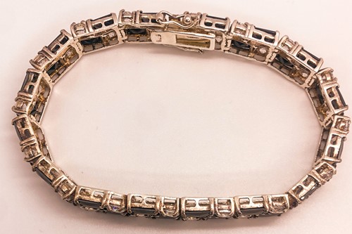 Lot 746 - A 9ct yellow gold and black CZ ring, together...