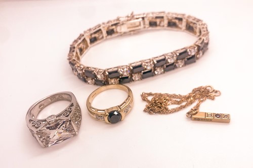 Lot 746 - A 9ct yellow gold and black CZ ring, together...