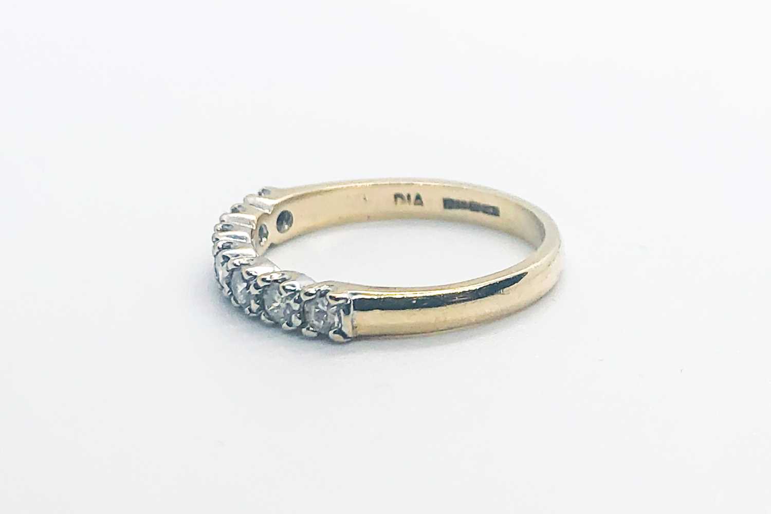 Lot 755 - A 9ct yellow gold and diamond half eternity